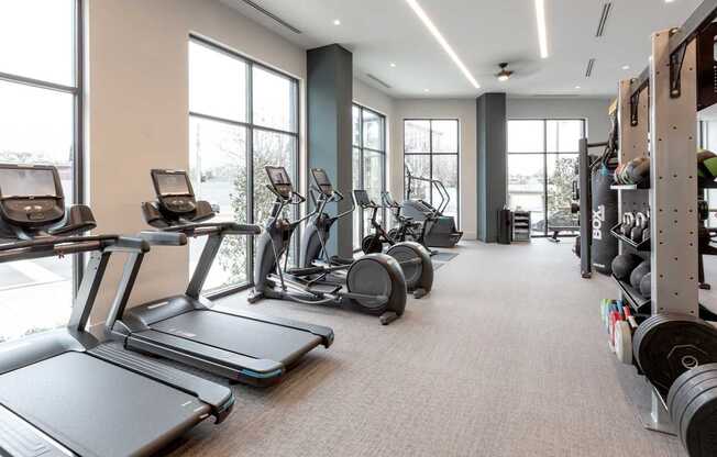 the gym with treadmills and weights at the belgard apartments