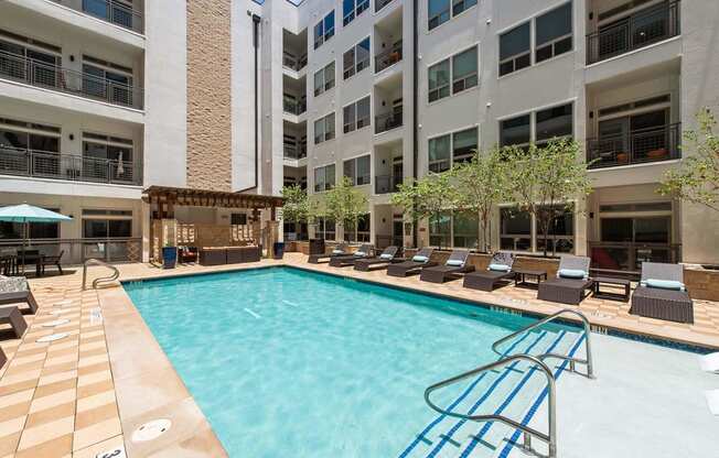 a swimming pool in front of an apartment building