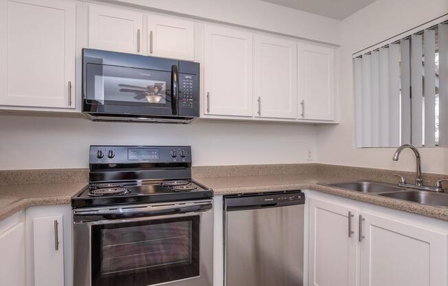 a stove top oven sitting inside of a kitchen