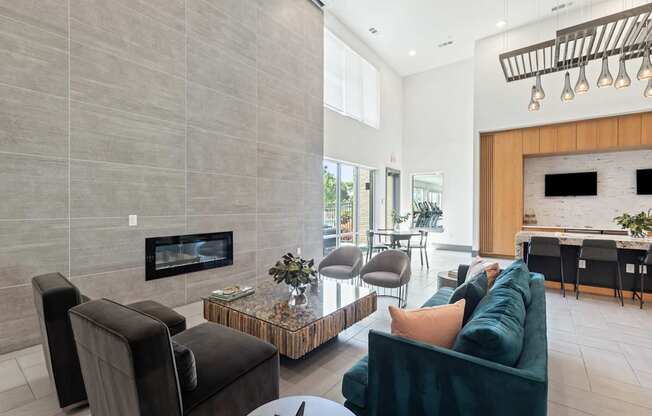 A modern living room with a fireplace and a green couch.