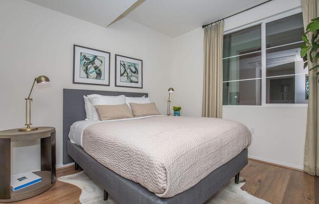 a bedroom with a bed and desk in a room