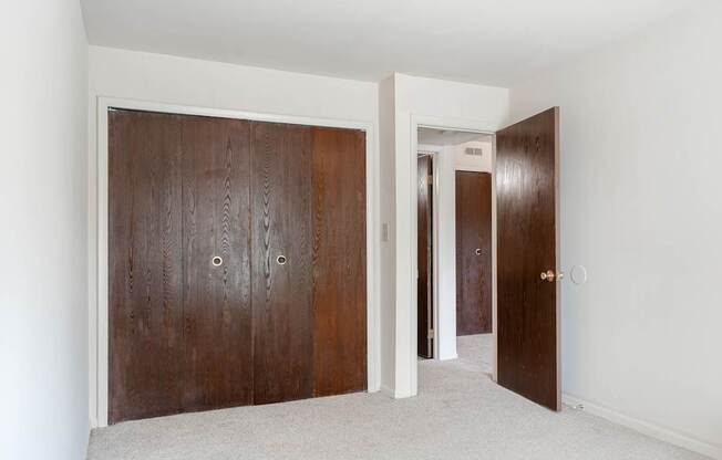 a room with two wooden doors and a carpeted floor