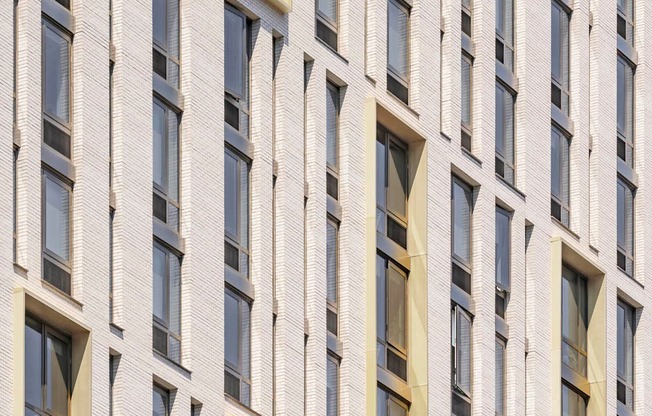 the facade of a building with many windows at The Lively, Jersey City, NJ