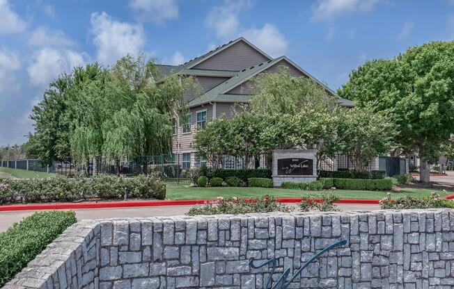 a stone bench in front of a brick building