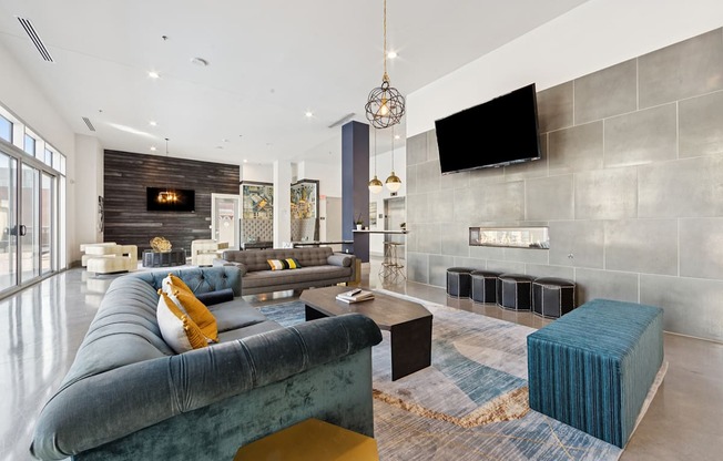 A modern living area with a blue sofa and a fireplace.