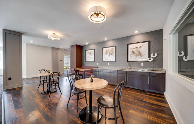 a dining room with a table and chairs and a kitchen