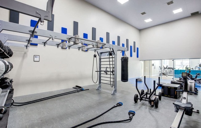 the gym atrium with weights and exercise equipment at the case building apartments