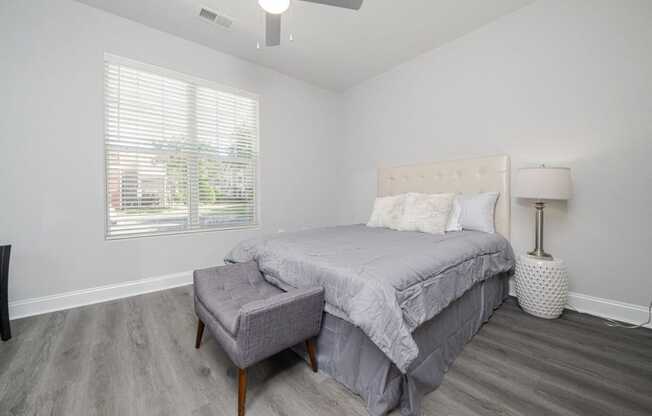 a bedroom with a bed and a ceiling fan