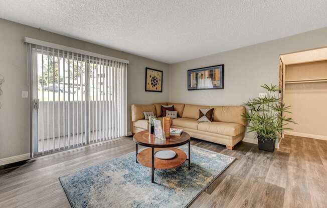 a living room with a couch and a sliding glass door at Desert Bay Apartments, Laughlin, Nevada, 89029