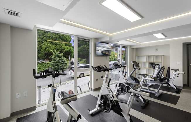 Well-Equipped Fitness Center with Exercise Equipment and Large Windows at Arabella Apartment Homes, Washington