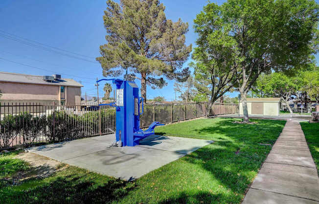 A blue playground structure in a sunny park.