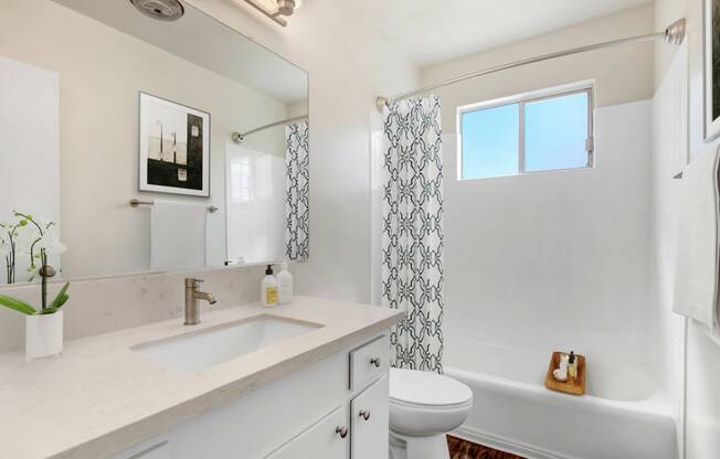 a bathroom with a sink toilet and a shower