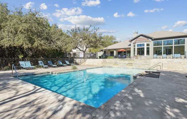 a swimming pool with a house in the background