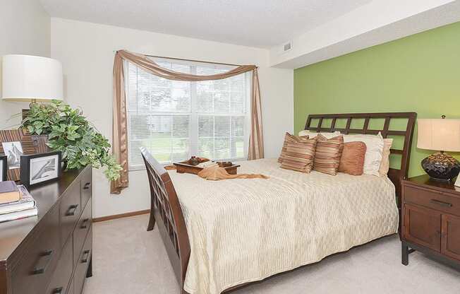 Green Accent Wall in Bedroom with Large Double Window