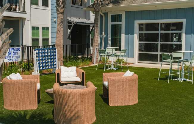 A sign in the background of a lawn reads "LIFEGUARD ON DUTY SWIM AT YOUR OWN RISK".