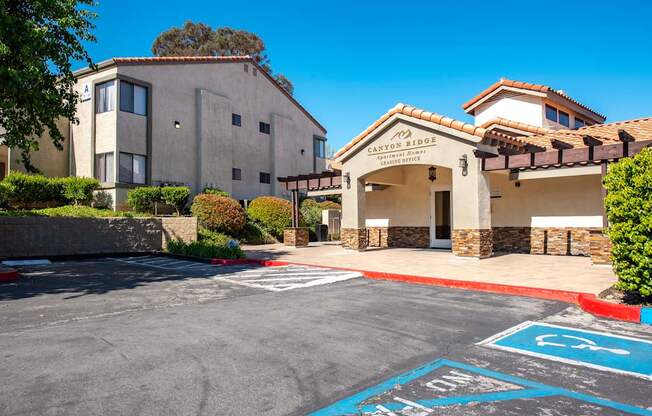 A parking lot with a building named Canyon Sides in the background.