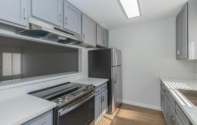 a kitchen with stainless steel appliances and wooden cabinets