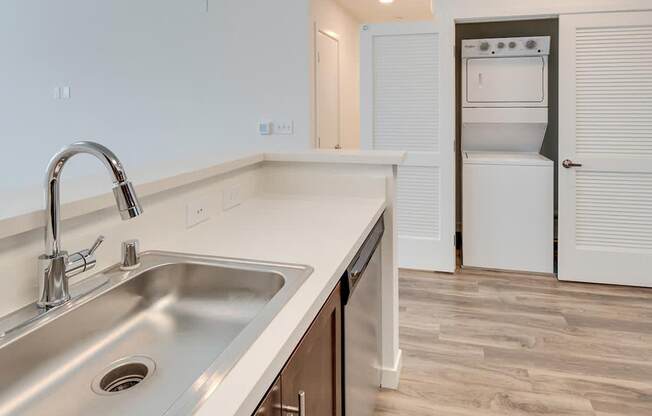 a kitchen with a sink and a washer and dryer