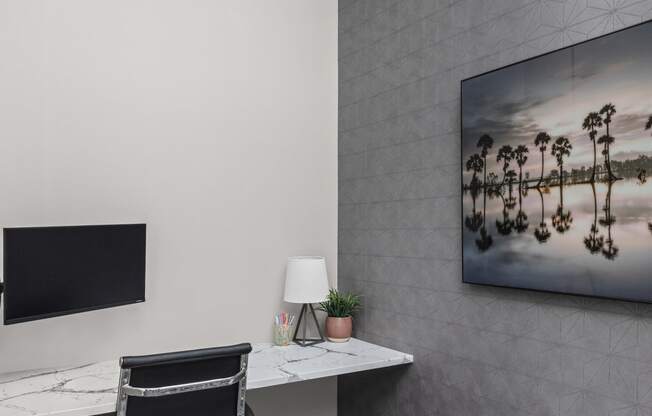 a home office with a desk and a large chandelier at The Sophia, Venice, FL, 34275