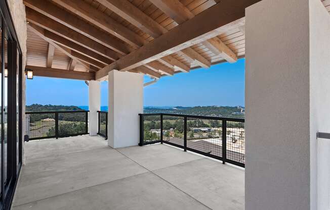 a balcony with a view of the city and the mountains