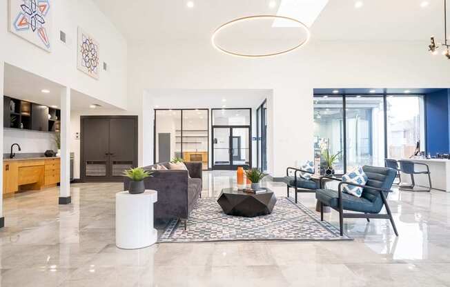 a living room with blue and white furniture and a large rug