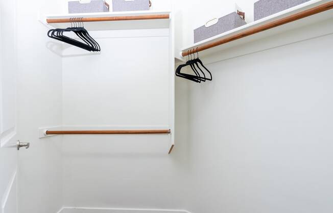 a white closet with a shoe rack on the wall
