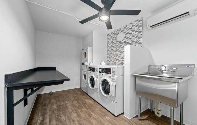 a laundry room with a sink and washer and dryer