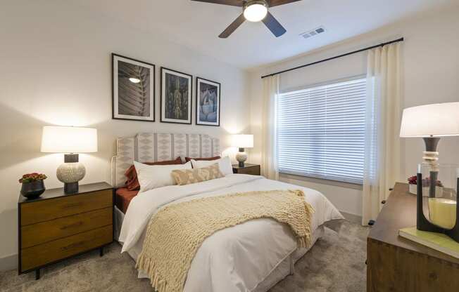 a bedroom with a large bed and a ceiling fan