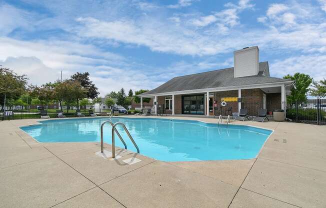 a swimming pool with a building in the background