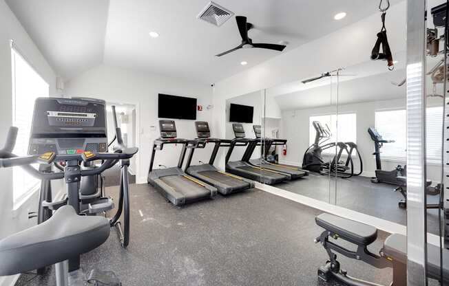 A spacious home gym with a variety of exercise equipment.