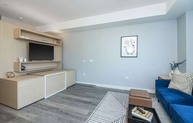 a living room with a blue couch and a television