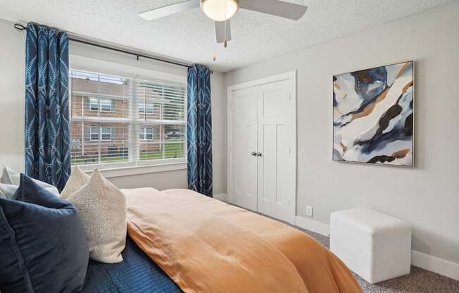 Cozy bedroom with plush carpeting and large windows at Reserve at Drakes Creek