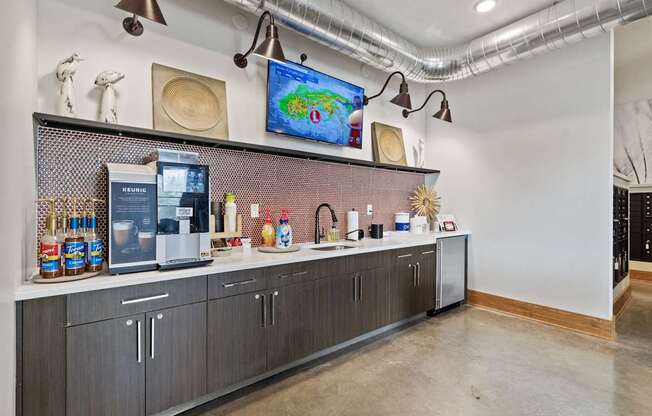 A kitchen with a refrigerator, microwave, and a counter with various items on it.