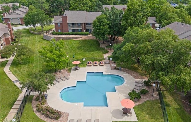 an aerial view of a swimming pool in the backyard of a house at Highland Park Apartment Homes, Overland Park