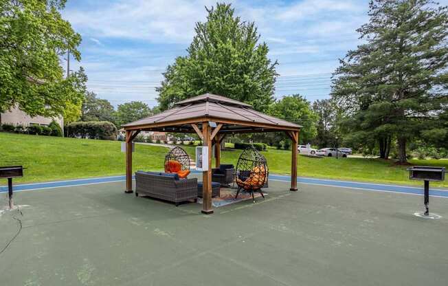 A gazebo with a basketball court in front of it.