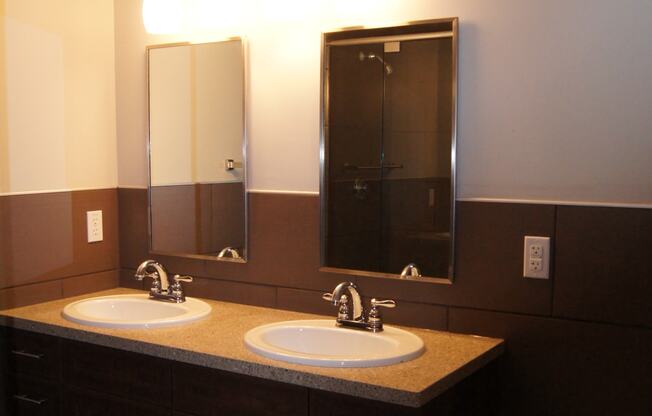 a bathroom with two sinks and two mirrors at Residences at South High, Pennsylvania, 15203?