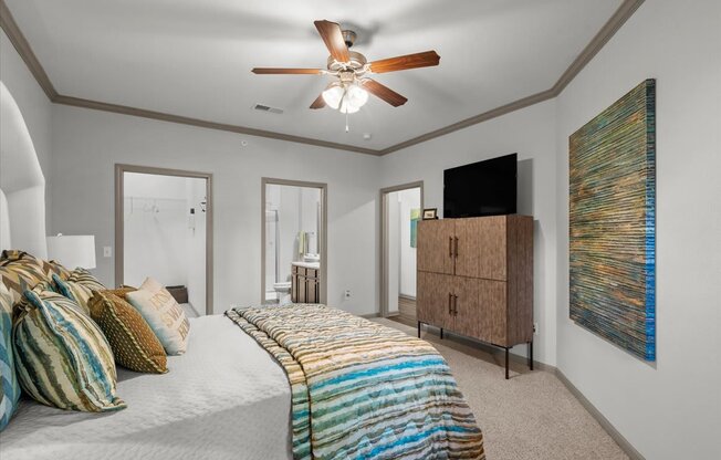 a bedroom with a bed and a ceiling fan