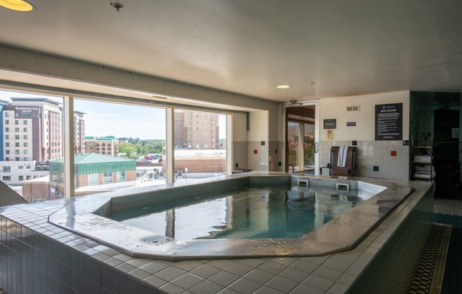 an indoor hot tub in a building with a view of the city at The Lucy Boise Apartments, Boise, ID