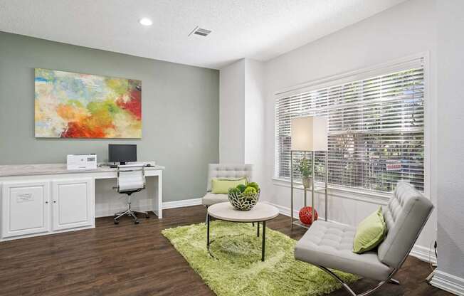 Business center with computer and seating with a coffee table at La Costa in Plano, TX
