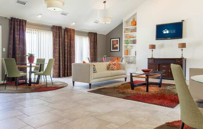 a living room and dining room with a table and chairs