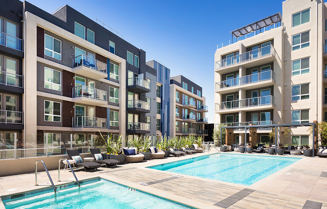 Resort-inspired pool and spa with private cabanas and chaise seating
