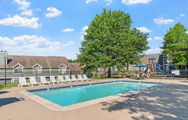 Relax by the sparkling pool under clear blue skies at this welcoming community.