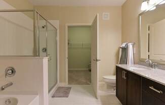 A bathroom with a toilet, sink, and shower.