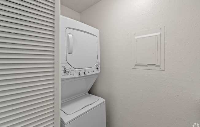 the laundry room has a washer and dryer and a window