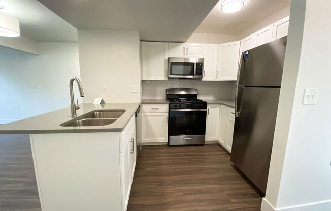 Two bedroom kitchen with hard surface floors and stainless steel appliances