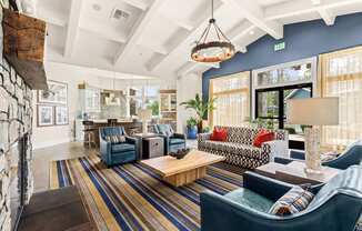 a living room with blue furniture and a fireplace