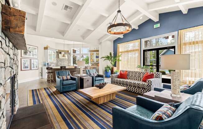 a living room with blue furniture and a fireplace