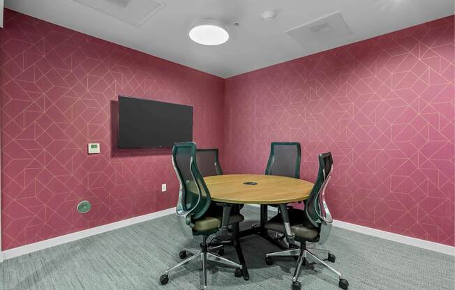 A conference room with a table and chairs.