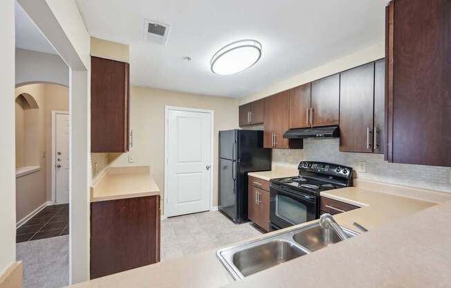 A kitchen with black appliances.