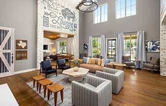 a living room with a couch and chairs and a table